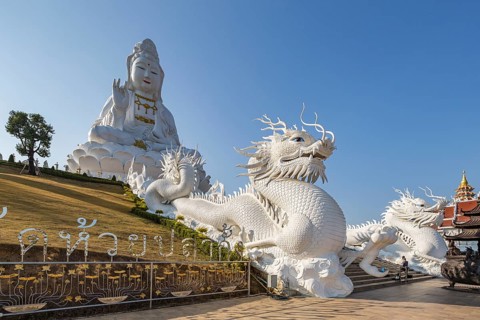 Chinese dragons line the steps up to the Guan Yin (Goddess of Mercy) statue at Wat Huay Pla Kang