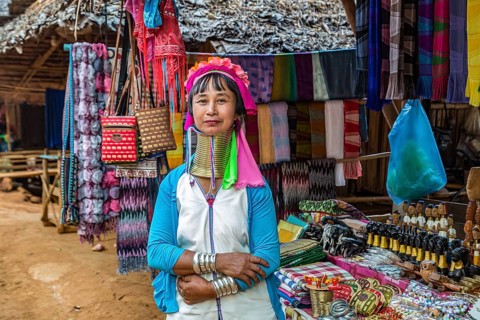 Tribal woman selling woven scarves and other crafts in the Long Neck Karen tribe (more properly