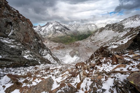 View of steep rocky mountain landscape with fresh snow in summer, in the Hornscharte, on the Wiener