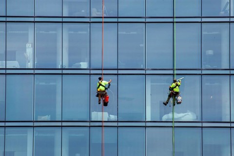 Detroit, Michigan - Window washers at the 25-story Residences Water Square luxury apartment