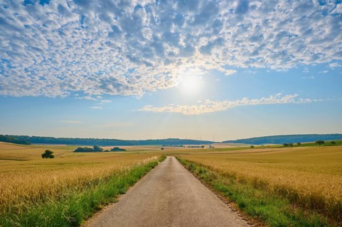 A country road leads through wide fields, the sky is cloudy and sunny, summer, Höhefeld, Wertheim,