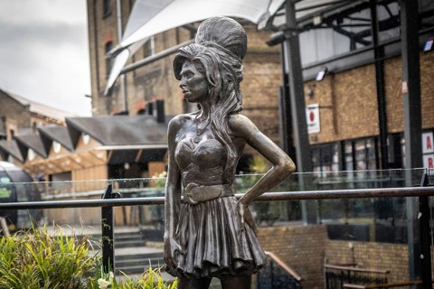 Bronze statue of the late singer amy winehouse, standing proudly in stables market, camden town,