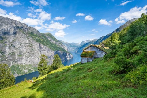 Blomberg Gård, historic mountain farm with grass roof on a steep mountainside above the