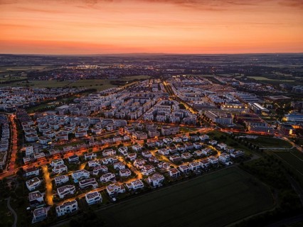 Dawn behind the Riedberg district of Frankfurt heralds the imminent sunrise. (Aerial view with a
