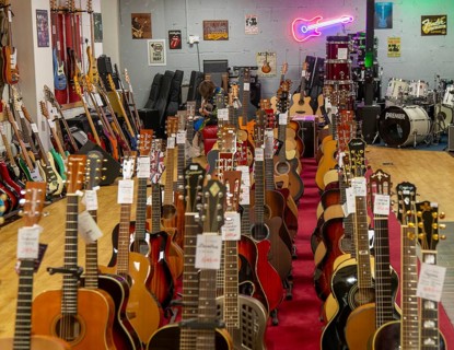 Guitars on display inside shop Sarum Guitars & Drums, Salisbury, Wiltshire, England, UK