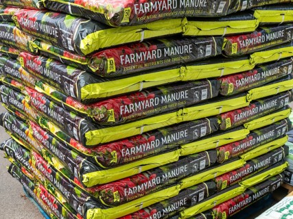 Farmyard manure bags stacked up at Lowden garden centre, Wiltshire, England, UK