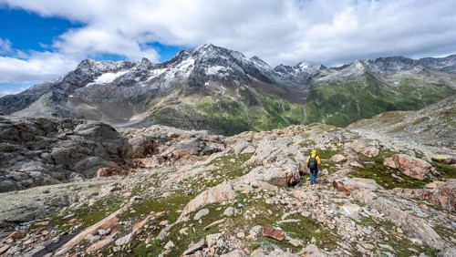 Mountaineer on hiking trail, rocky mountain landscape, behind mountain peak Roter Knopf with fresh