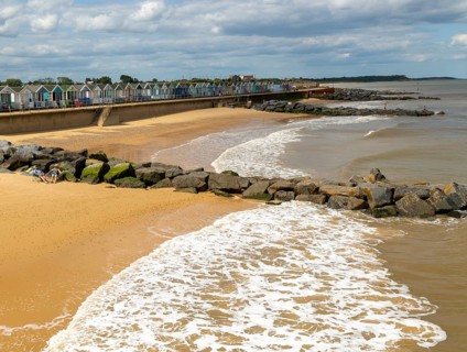 View north of sandy beach and coastal defences from pier, Southwold, Suffolk, England, UK