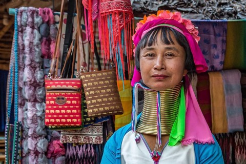 Tribal woman selling woven scarves and other crafts in the Long Neck Karen tribe (more properly