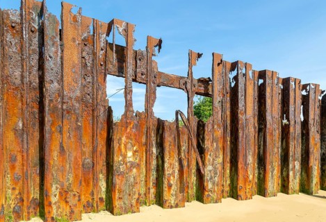 Old rusty broken steel sheet piling sea wall coastal defence, River Deben, Bawdsey, Suffolk,