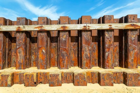 Old rusty steel sheet piling sea wall coastal defence, River Deben, Bawdsey, Suffolk, England, UK