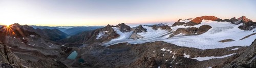 Panorama at sunrise with sun star, high mountain landscape, view of blue glacial lakes, mountain