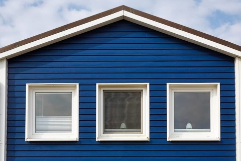 Blue lobster shack, wooden façade with three windows, façade detail in the harbour, Heligoland,