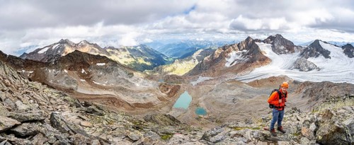 Mountain panorama, mountaineer with helmet on a rocky hiking trail, in high mountain landscape,