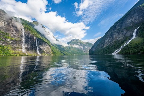 Atmospheric fjord landscape with waterfall The Seven Sisters and Freier Waterfall, Geirangerfjord