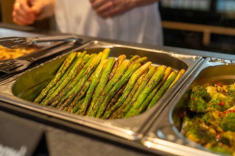 Asparagus and broccoli on a tray in a buffet setting in the kitchen, event and wedding location