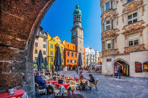 Street café on Herzog-Friedrich-Strasse with the Helblinghaus and city tower in the old town,