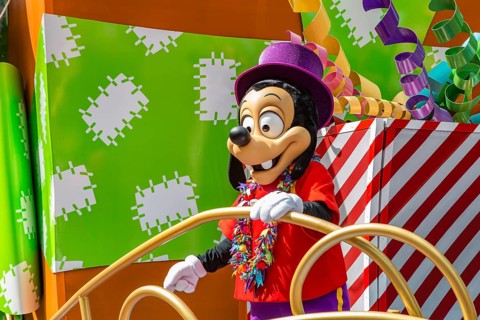 Disney character riding on float during parade through the Frontierland area of Magic Kingdom at