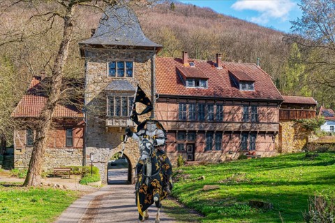 Knight on horseback in front of gatehouse to Schaumburg Germany Composing