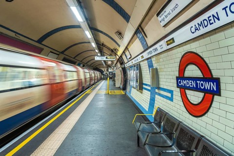 Motion blur of a london underground train arriving at camden town station with its distinctive