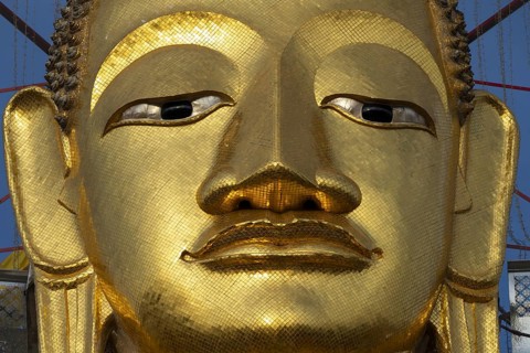 Face of a 32 metre high standing Buddha decorated with glass mosaics and 24-carat gold, Luang Pho