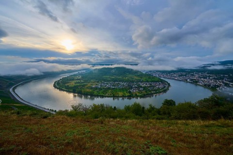River landscape in sunrise mood with clouds and haze in the air, summer, Rhine bend Boppard,