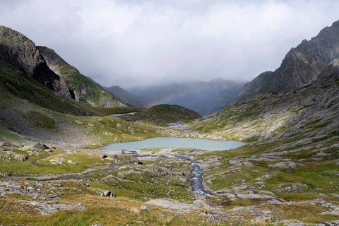 Turquoise-blue mountain lake Mittersee and rainbow, Schober group, Hohe Tauern National Park,