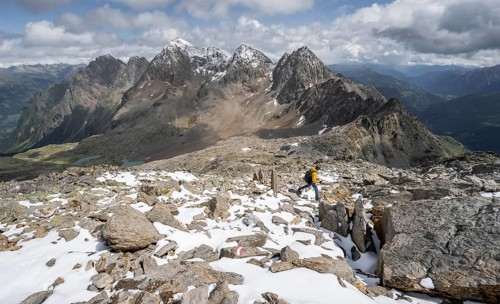 Mountaineer in rocky mountain landscape, descent from the summit of Keeskopf, behind summit of