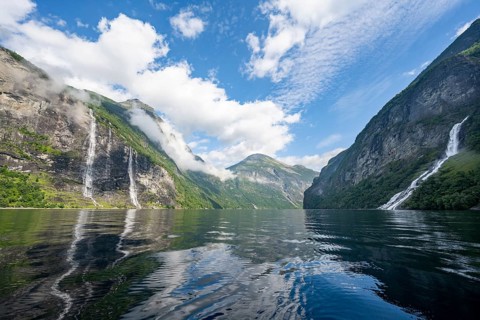 Atmospheric fjord landscape with waterfall The Seven Sisters and Freier Waterfall, Geirangerfjord
