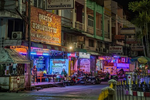 Massage parlor employees waiting for customers along a steet in Chiang Rai, Thailand, Asia