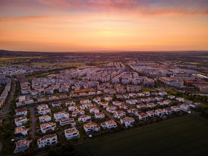 Dawn behind the Riedberg district of Frankfurt heralds the imminent sunrise. (Aerial view with a