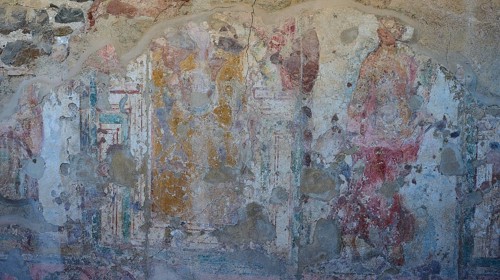 Faded frescoes on ancient wall with figures and paint remains, Archaeological Site, House of Beluga