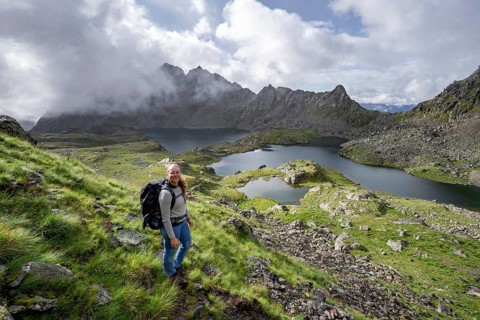 Mountaineer on hiking trail, view of mountain landscape with mountain lakes Wangenitzsee and