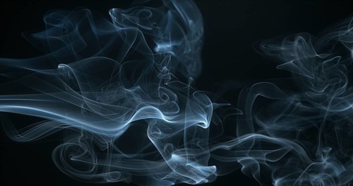 Smoke of Cigarette rising against Black Background
