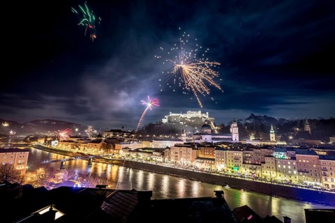 Colorful firework in the night: Old city of Salzburg and Festung Hohensalzburg at New Year?s Eve.