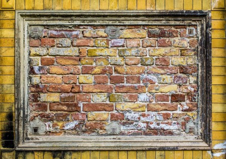 Old brick wall pattern closeup with stucco frame