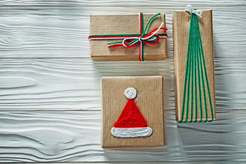 Handmade Christmas gift boxes on wooden board Celebration concept