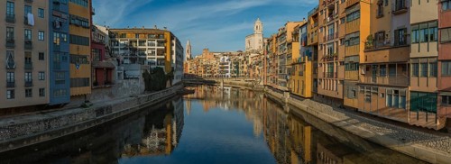 A panorama picture of Girona's Onyar river and its adjacent colorful buildings