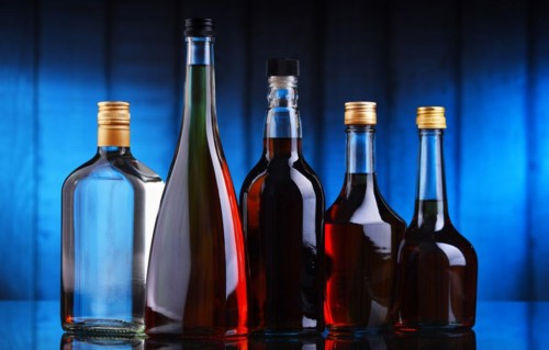 Composition with bottles of assorted alcoholic beverages