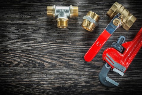 Sanitary monkey spanner connections water valve on vintage wooden board