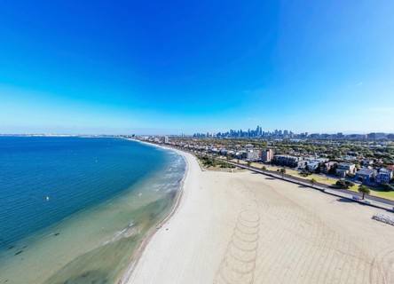 View towards Melbourne skyline on a warm summer's morning from St Kilda West Beach in Australia