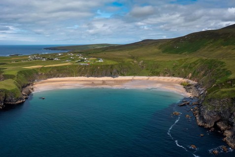 A drone aerial view of the beautiful Silver Strand and horseshoe bay at Malin Beg on the Wild