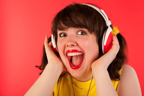 Young woman is exciting about hearing good music