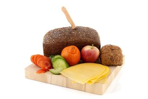 Making healthy brown bread with cheese fruit and vegetables