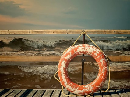 Storm at the sea, pier with life buoy