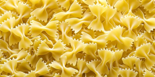 Pasta in the form of butterflies scattered in the background image