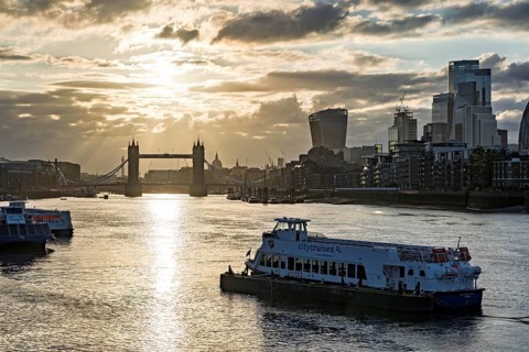 View over the Thames with Tower Bridge and the skyline in the evening light, London, England, Great
