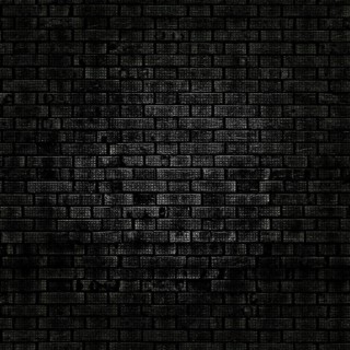 Dark grunge brick wall texture creating a dramatic and textured background, ideal for design