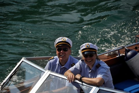 A smiling couple of water-police-officers on the Limmat-River with the major of Zürich City on