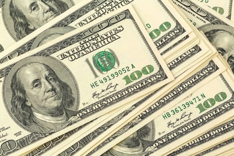 Many American dollar banknotes. Symbolic photo for debt and wealth Austria